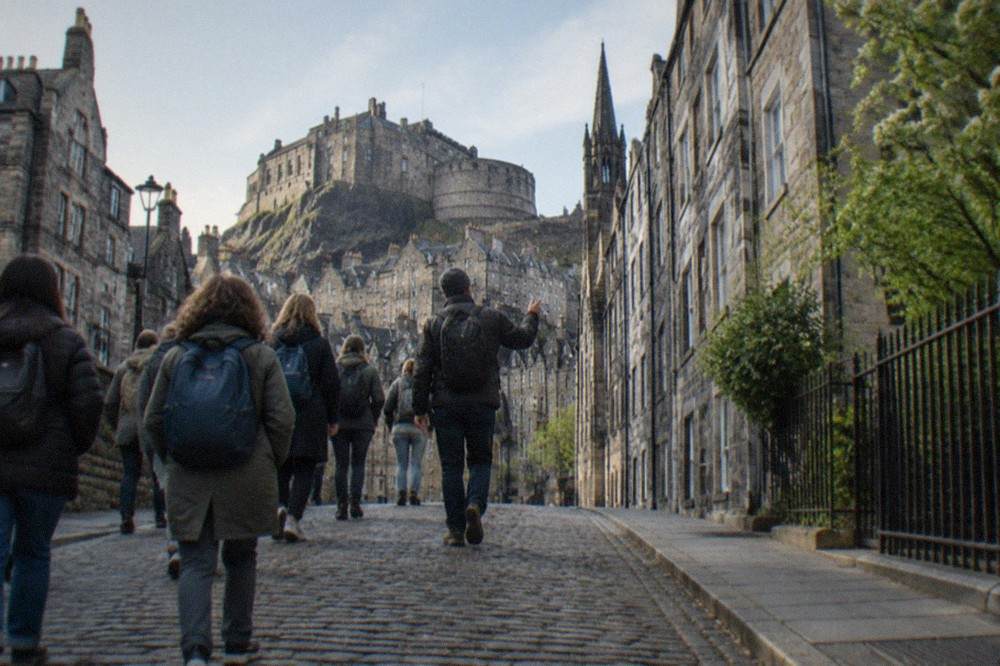 The Royal Mile climbing towards Edinburgh Castle with old stone buildings on both sides