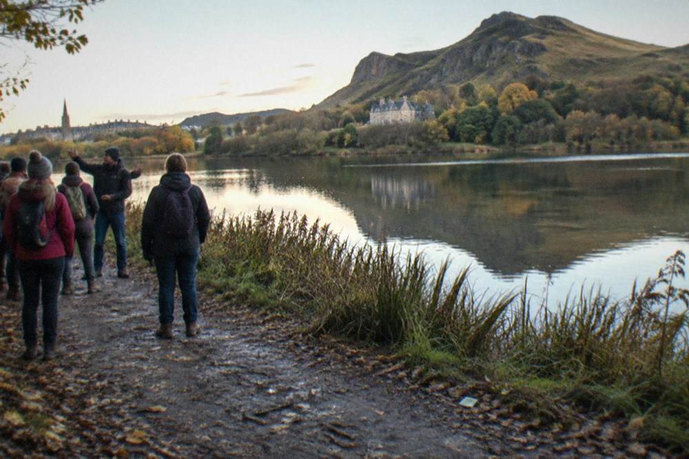 Still loch in Holyrood Park reflecting the crags of Arthur's Seat in early light