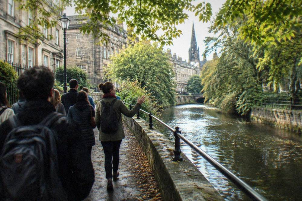 Riverside footpath along the Water of Leith with trees overhanging the water