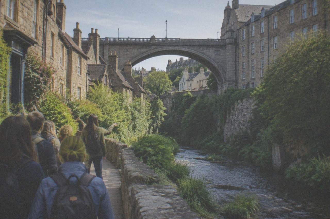 Stone cottages beside the Water of Leith in Dean Village with a stone bridge spanning the river