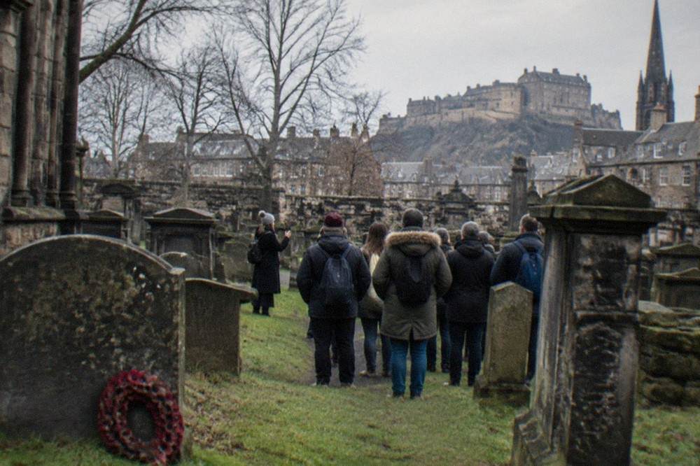 Weathered grey gravestones packed closely together under an overcast sky