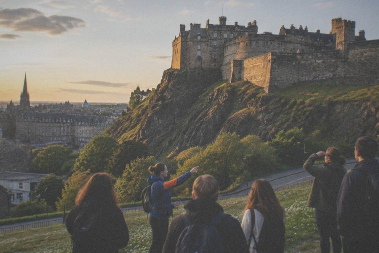 Edinburgh Castle rising above the city skyline from Princes Street Gardens