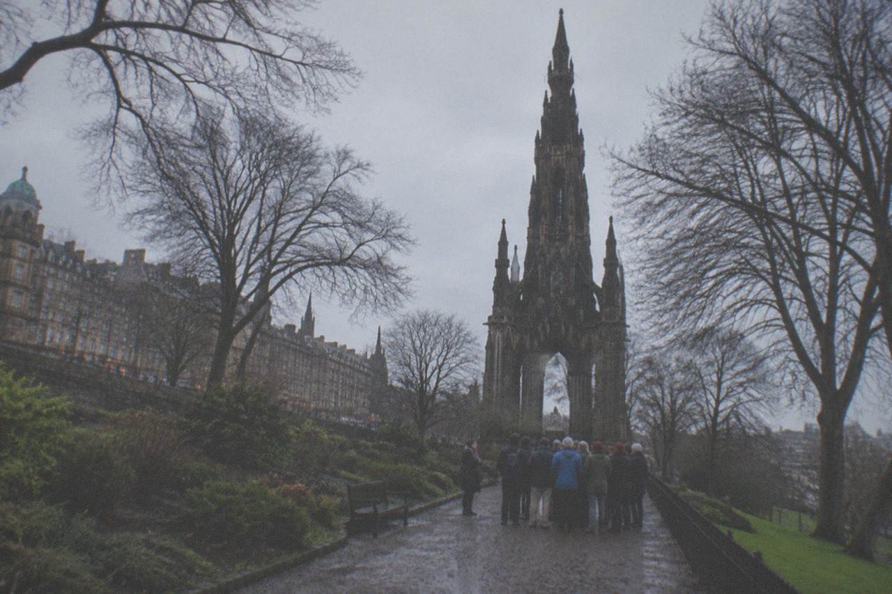 Edinburgh old town rooftops and a church spire under an overcast sky