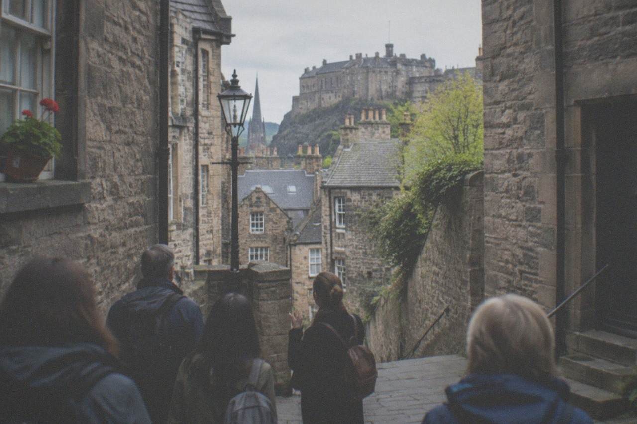 A quiet cobblestone close in Edinburgh's Old Town with stone steps and old buildings