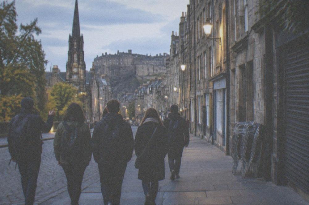 The Royal Mile in the evening with street lamps lit and the street quieting