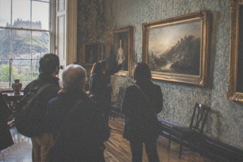 Classical art gallery room with framed paintings hung on patterned walls