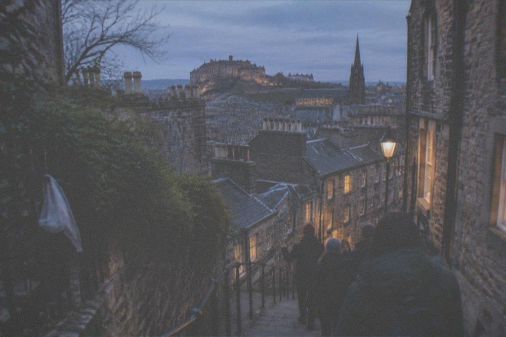 Edinburgh's Old Town rooftops and chimneys seen from an elevated close at dusk